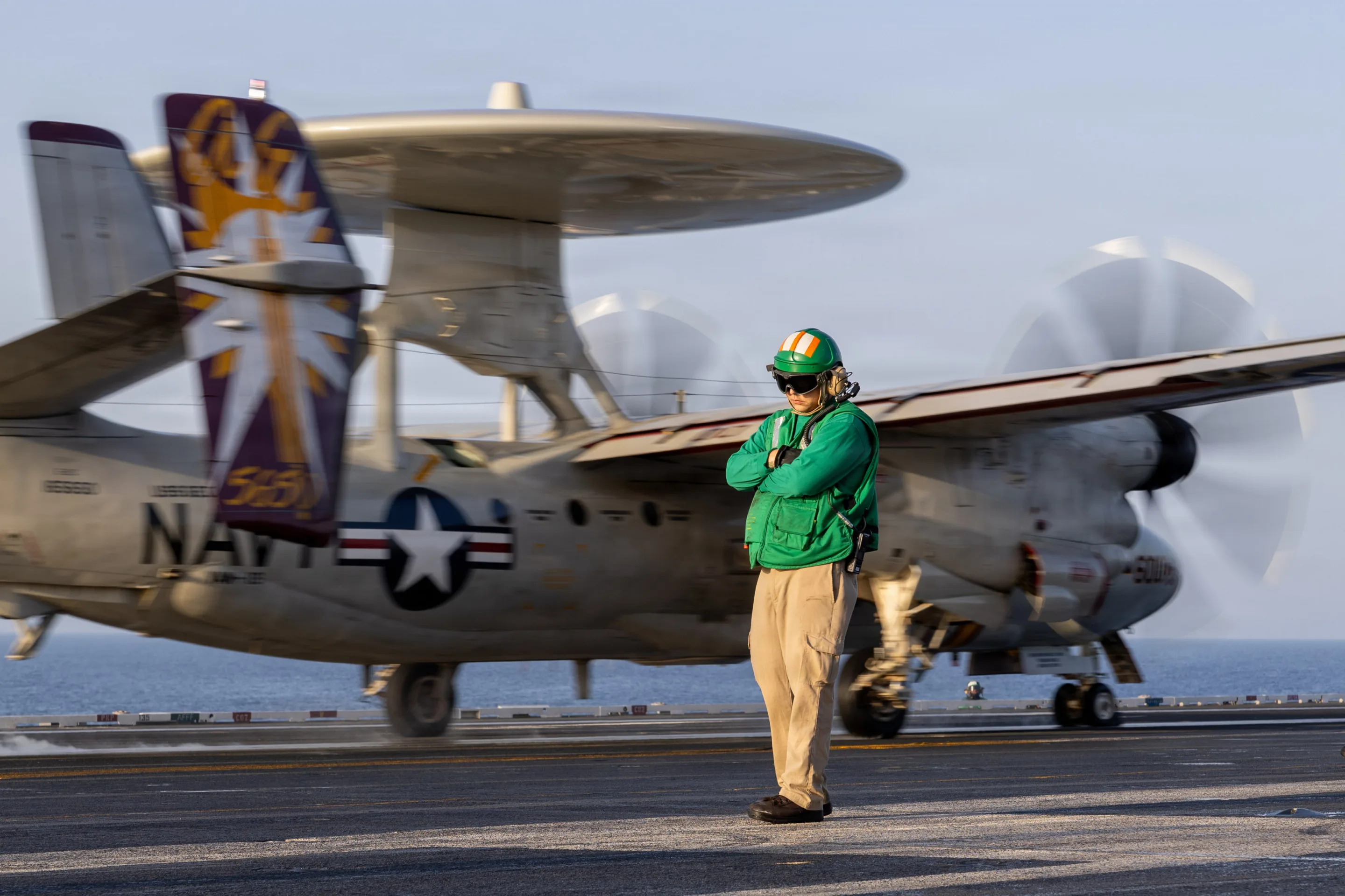 Navy Sailor on Flight Deck with Plane in Background